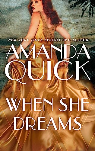 Book cover: woman in gold dress, ocean view, title “When She Dreams.”