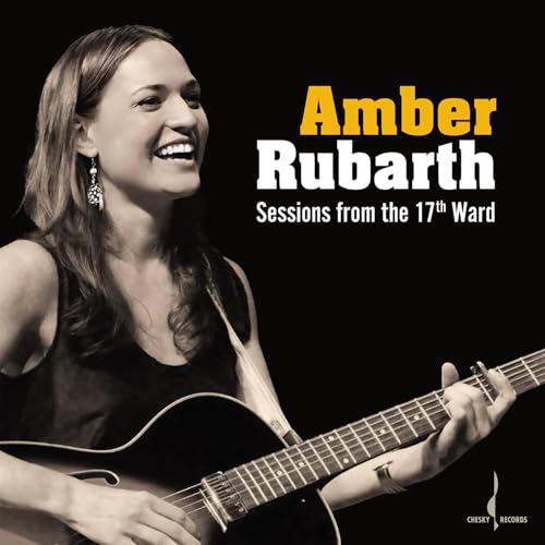 Amber Rubarth smiling, playing guitar on CD cover in grayscale.
