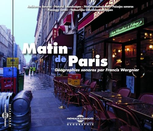 Empty Parisian street scene with sidewalk cafe tables and chairs in the early morning.