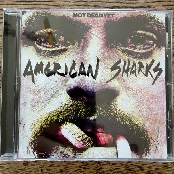 CD case with distressed portrait of a man and band name "American Sharks".