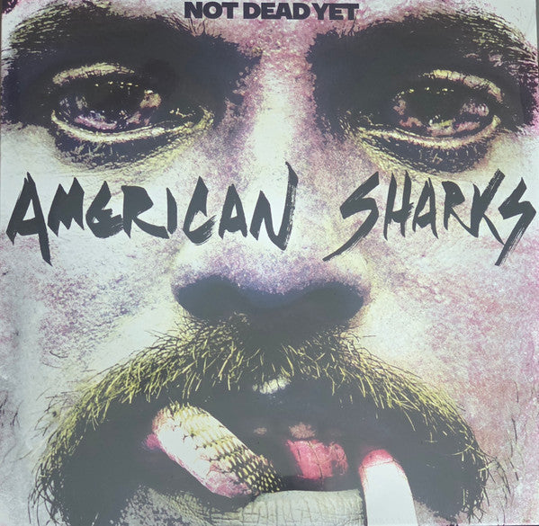 Album cover for American Sharks’ “Not Dead Yet” featuring a snarling face.