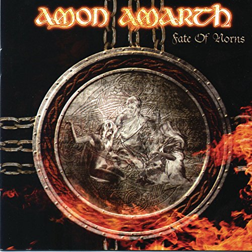 Amon Amarth album cover featuring a metal disc with engraved figures surrounded by flames.