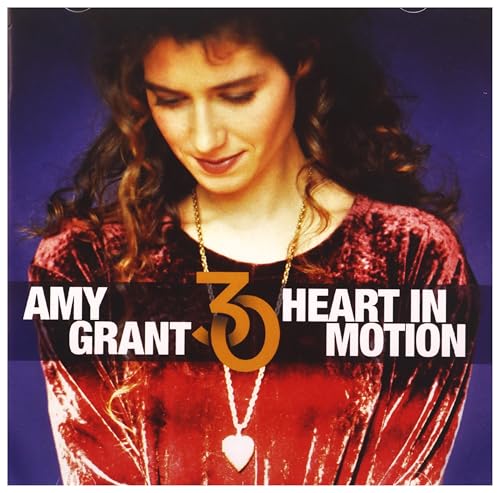 Amy Grant wearing a heart necklace on the Heart in Motion 30th anniversary CD cover.