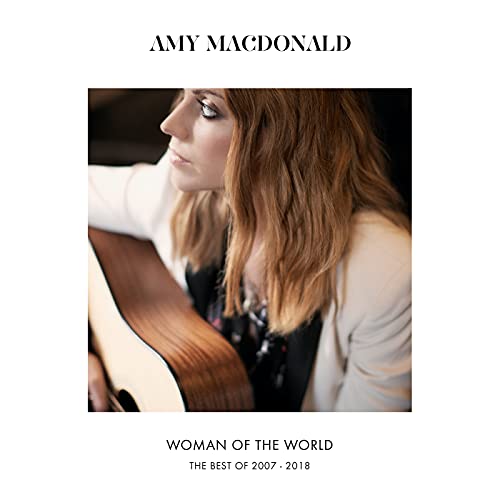 Amy Macdonald holding an acoustic guitar, album cover for Woman of the World.