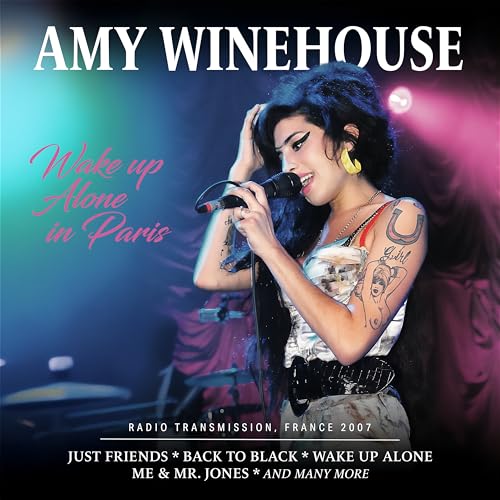 Amy Winehouse singing into a microphone on a concert stage.
