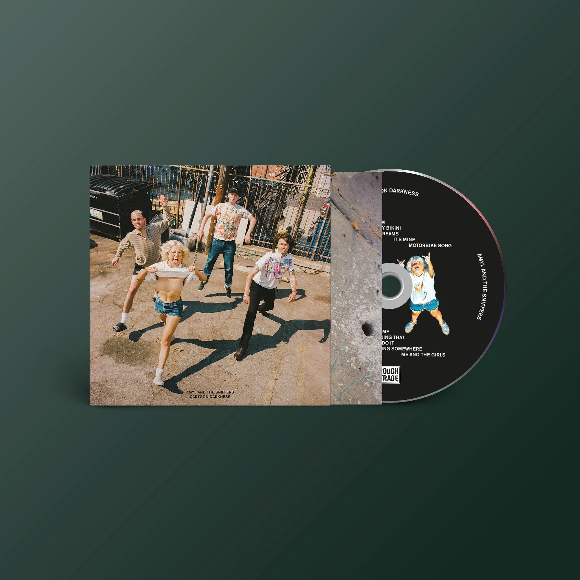 CD cover featuring a band running down a dusty road, sepia tone.