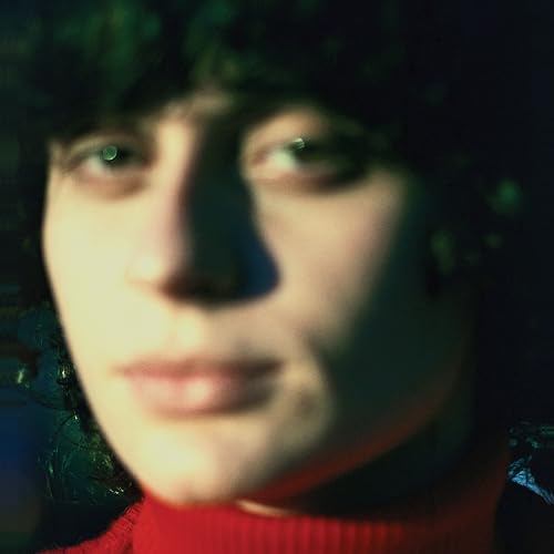 Close-up portrait of a person with dark hair and a red sweater.