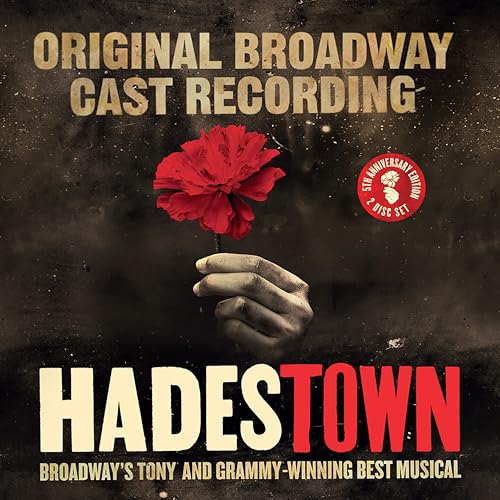 A hand holds a red flower against a dark background, with Hadestown text below.
