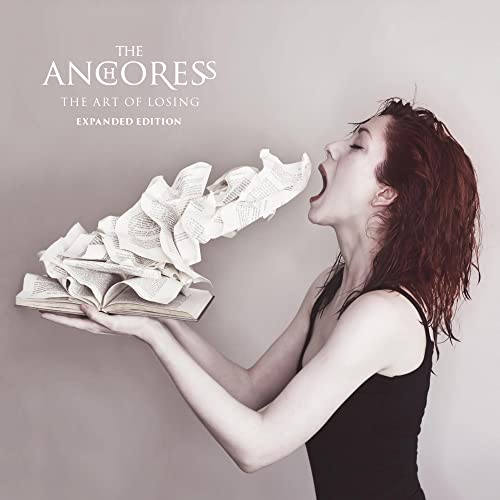 Woman with red hair exhales pages from an open book.