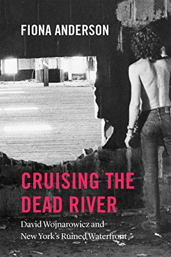 Book cover featuring a partial view of a man’s back and industrial landscape.