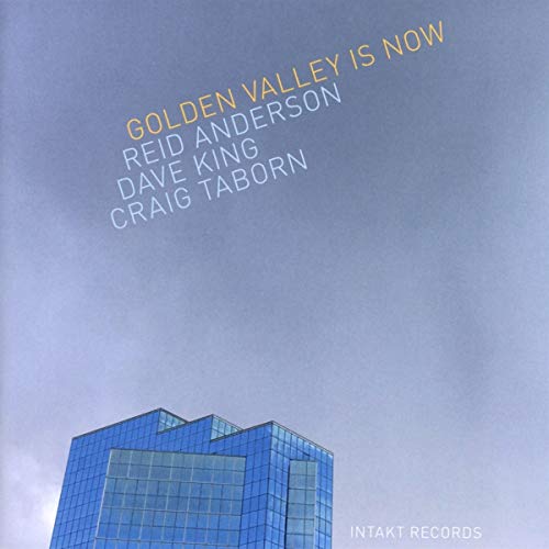 "Album cover with blue building and text listing artists and title."