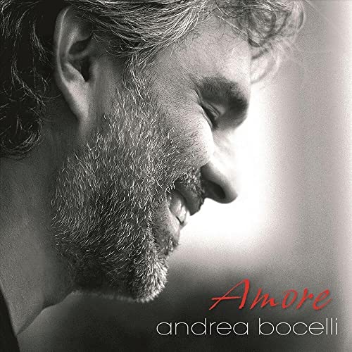 Close-up of Andrea Bocelli with “Amore” text on a vinyl record cover.