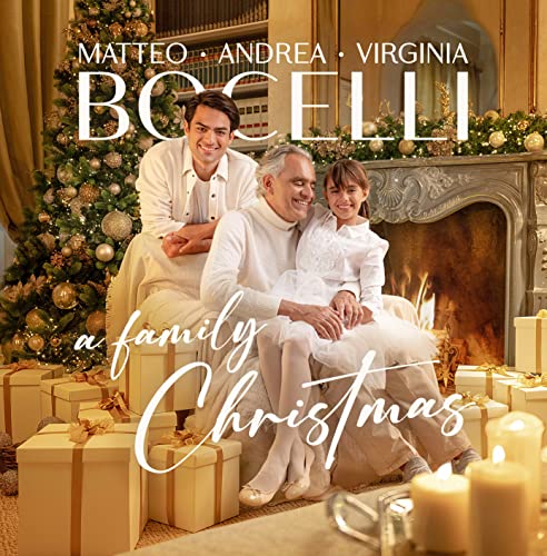 Bocelli family portrait with a Christmas tree and gifts.