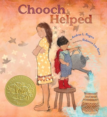 A girl stands beside a boy on a stool watering a pot with a can.