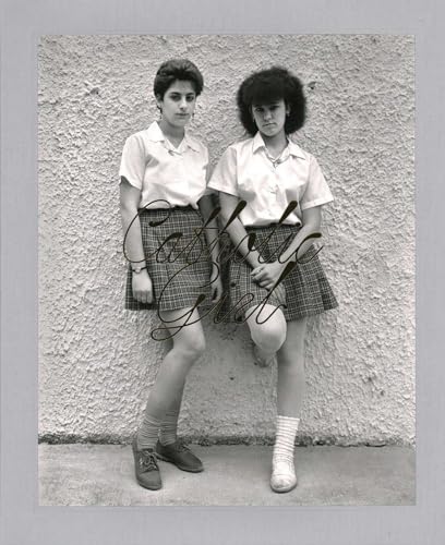 Two young women in school uniforms pose against a textured wall.