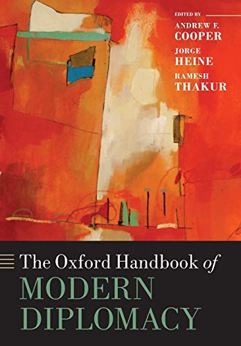 Book cover: “The Oxford Handbook of Modern Diplomacy” with abstract art.