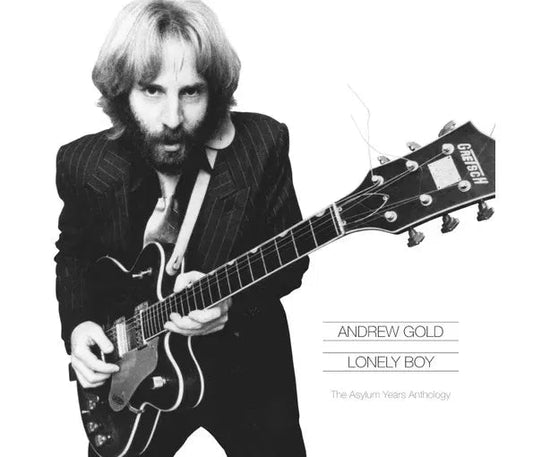Black and white photo of Andrew Gold playing a Gretsch electric guitar.