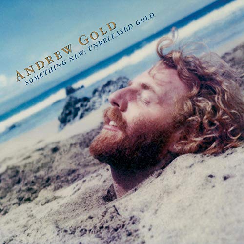 Vinyl album cover featuring a man with curly hair lying on a beach.