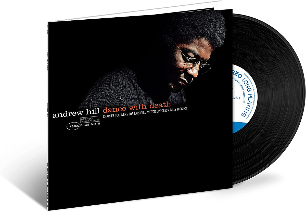 Vinyl record sleeve with a man's portrait and a black vinyl record partially visible.