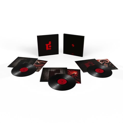 Three black vinyl records and their matching black and red album covers.