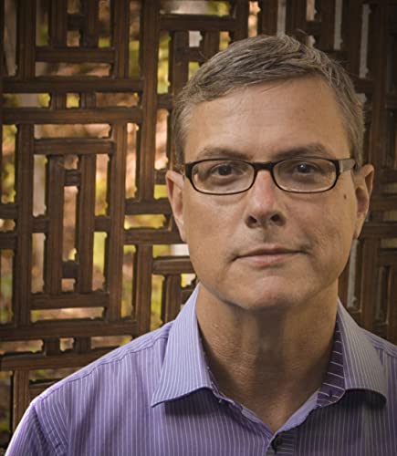 Headshot of a man with short grey hair and black-rimmed glasses.