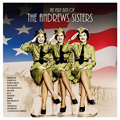 The Andrews Sisters in military uniforms saluting in front of an American flag.