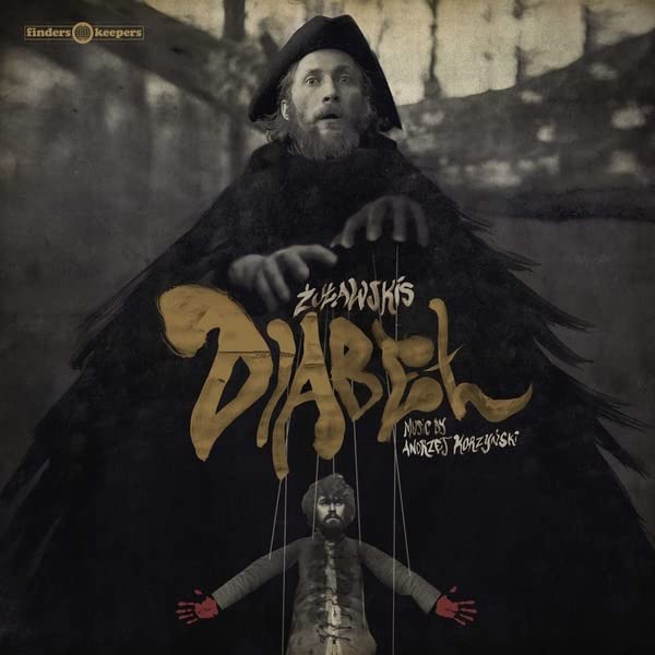 Vinyl album cover featuring a man in black with puppet strings.