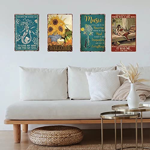 Three framed floral and text art pieces hang above a white sofa.