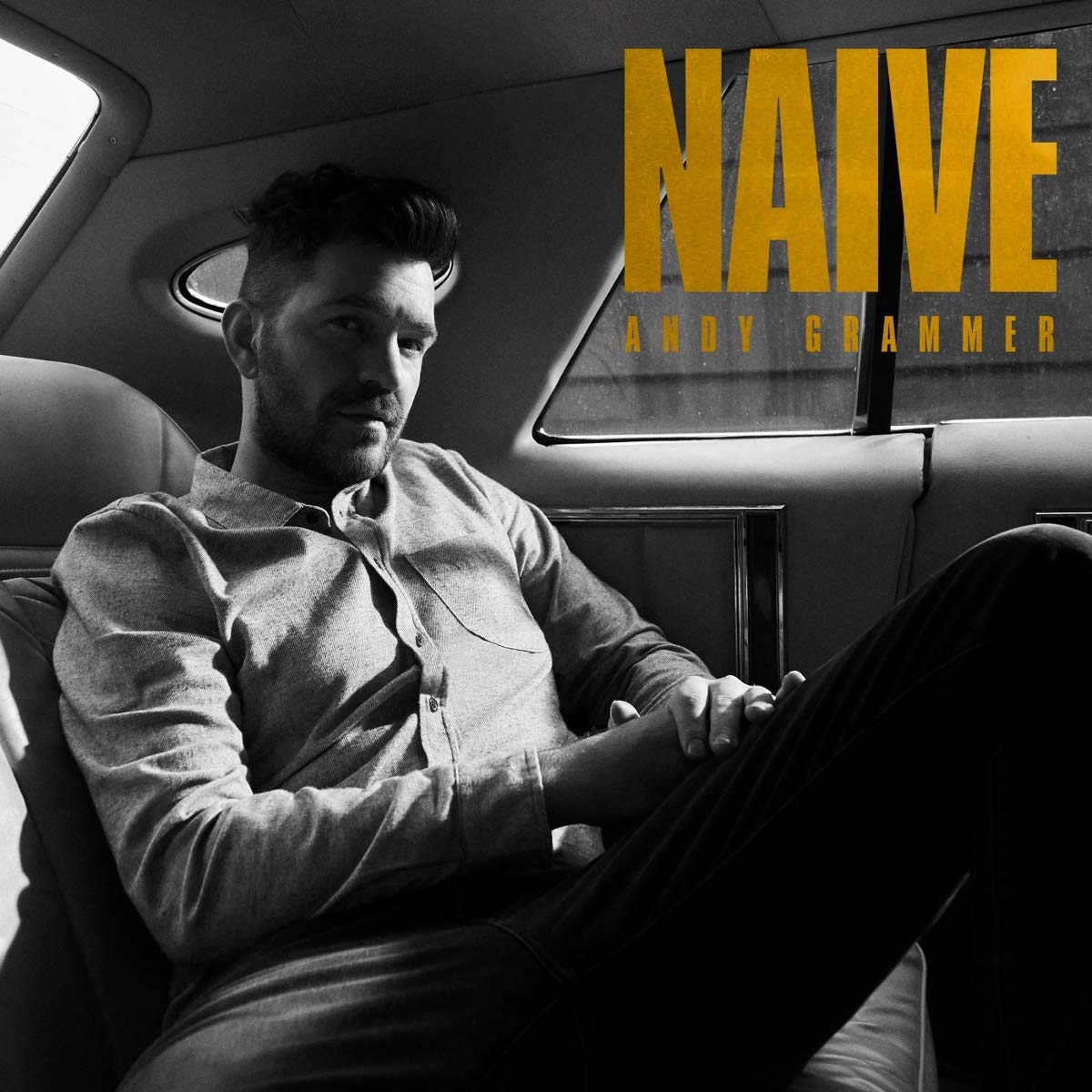 Album cover with man sitting in a car, titled "Naive" by Andy Grammer.