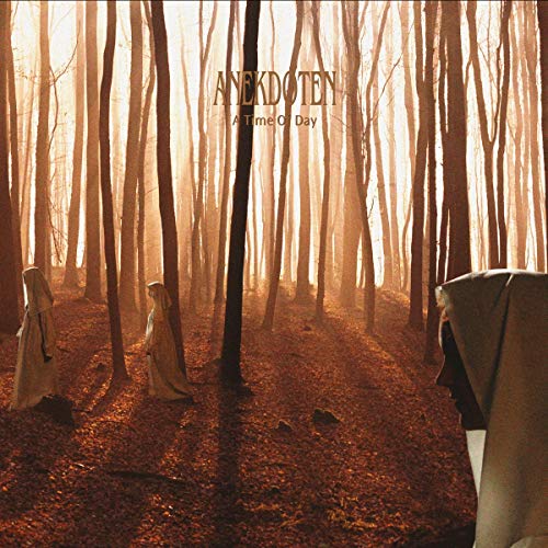 The alt text for the image is: "Vinyl album cover with dark forest scene and hooded figures."