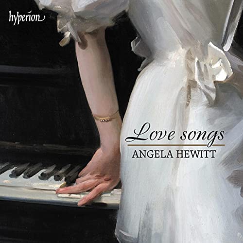 Close-up of hands playing a piano, with white fabric and text.