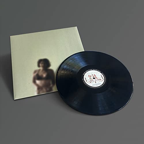 Vinyl record and sleeve with a blurred portrait of a woman.
