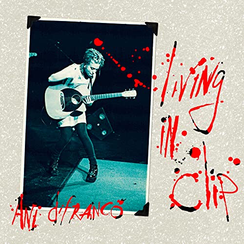 Ani DiFranco playing guitar, with red paint splatters and text overlay.