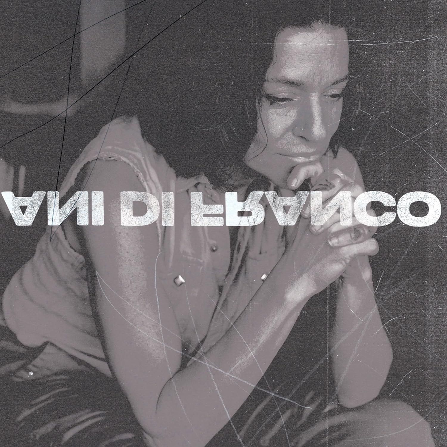 Black and white album cover featuring Ani DiFranco with hands clasped in contemplation.