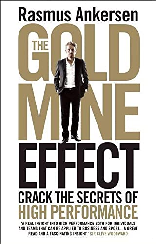 Book cover featuring a man in a suit against large gold and black text.