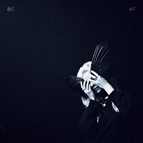 Dark album cover featuring a person with a feathered headpiece.