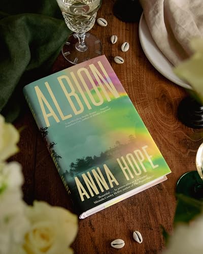 The book Albion by Anna Hope rests on a wooden table with scattered shells.