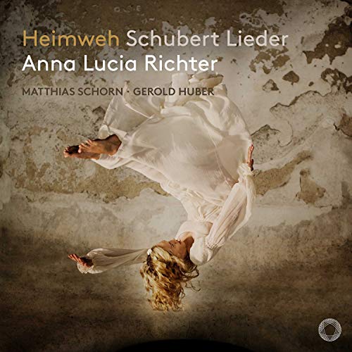 A CD cover featuring a woman in a white dress falling upside down.