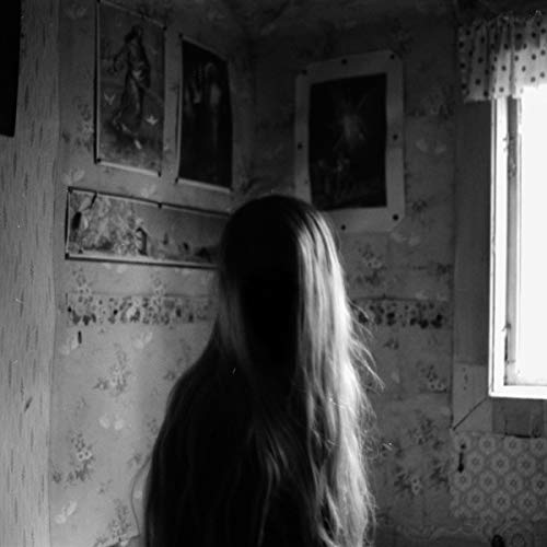 Black and white album cover featuring a person with obscured face.