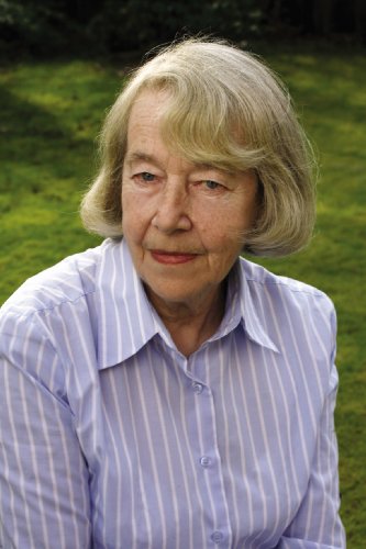 Portrait of an older woman with short blonde hair, smiling gently.