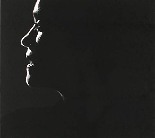 Black and white profile of a person’s face in shadow.