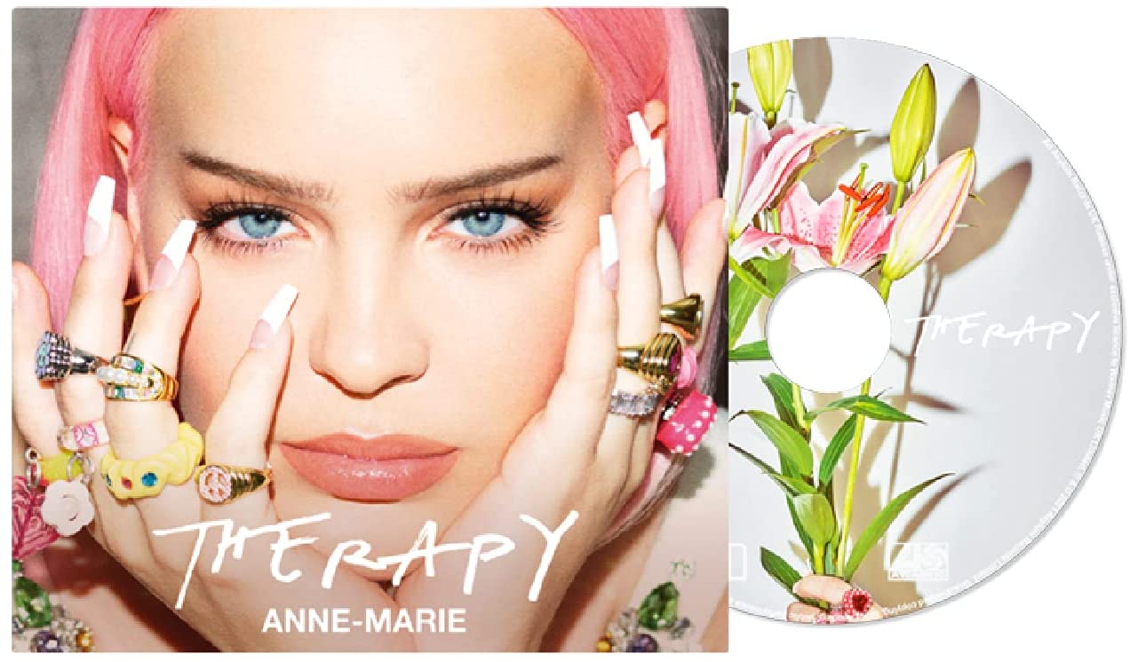 "Album cover featuring a woman with pink hair and multiple rings on her fingers."