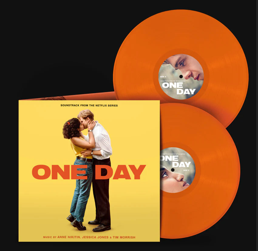 Orange vinyl record with "One Day" album cover featuring a couple kissing.