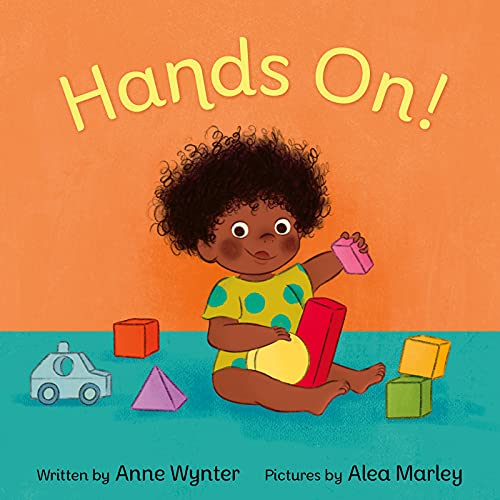Children's book cover with a young child playing with colorful blocks.