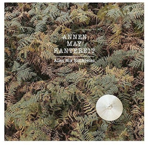 Album cover featuring dense green ferns and a white cymbal with text overlay.