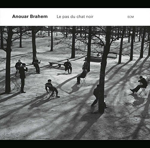 Black and white album cover with people in a tree-lined park.