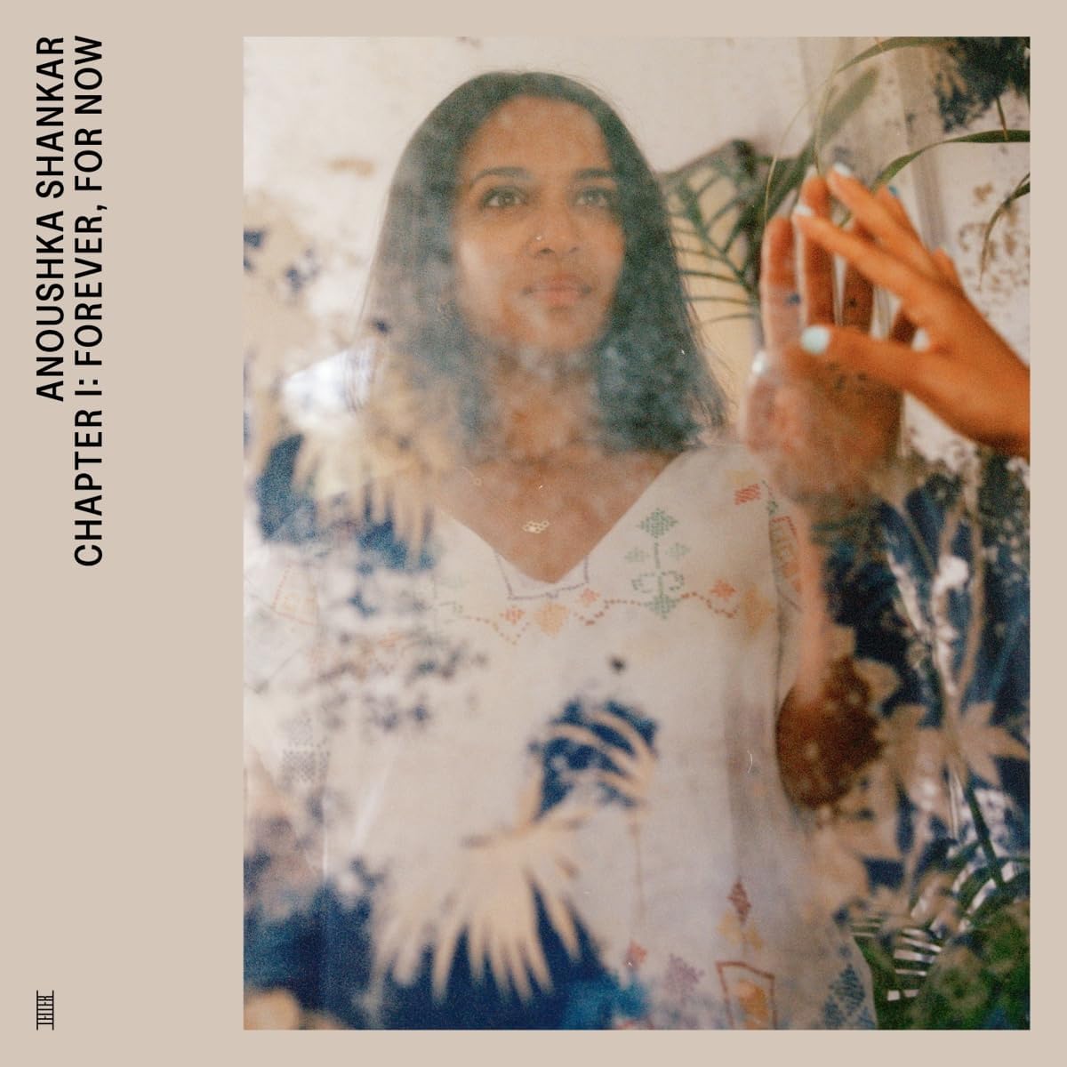 "Blurry album cover with a woman in a white floral dress and plants."