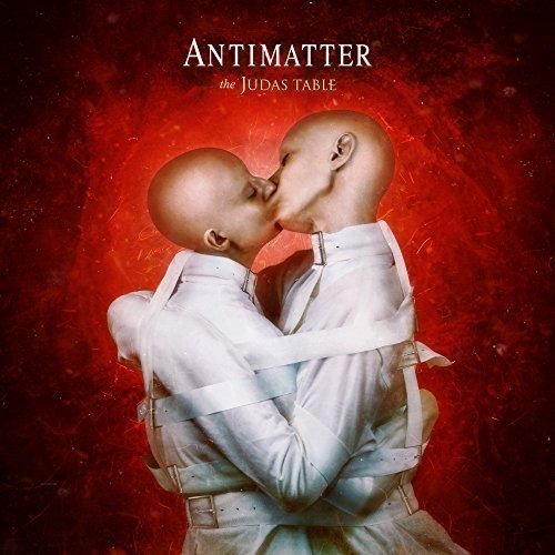 "Album cover featuring two bald figures embracing, bound together, against a red background."