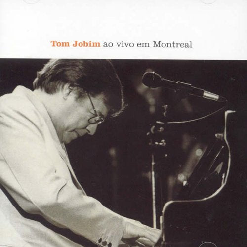 Tom Jobim at a piano with a microphone, album cover art.