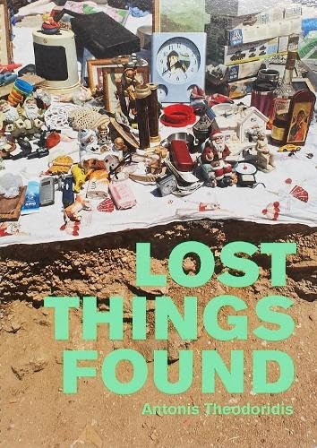 Book cover showing a collection of small objects above a dirt excavation site.